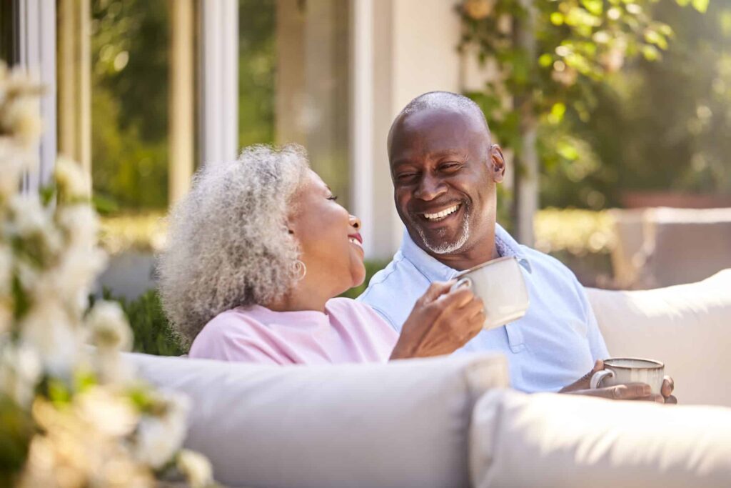 Hoping to Retire Soon? 2 Stocks You Can Rely on for Monthly Passive Income Retirees sip their morning coffee outside.