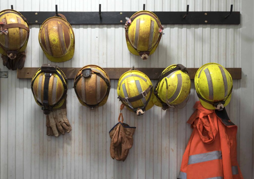 Canada Lost 68,000 Jobs in September: The October 28 Rate Call Just Got Harder Safety helmets and gloves hang from a rack on a mining site.