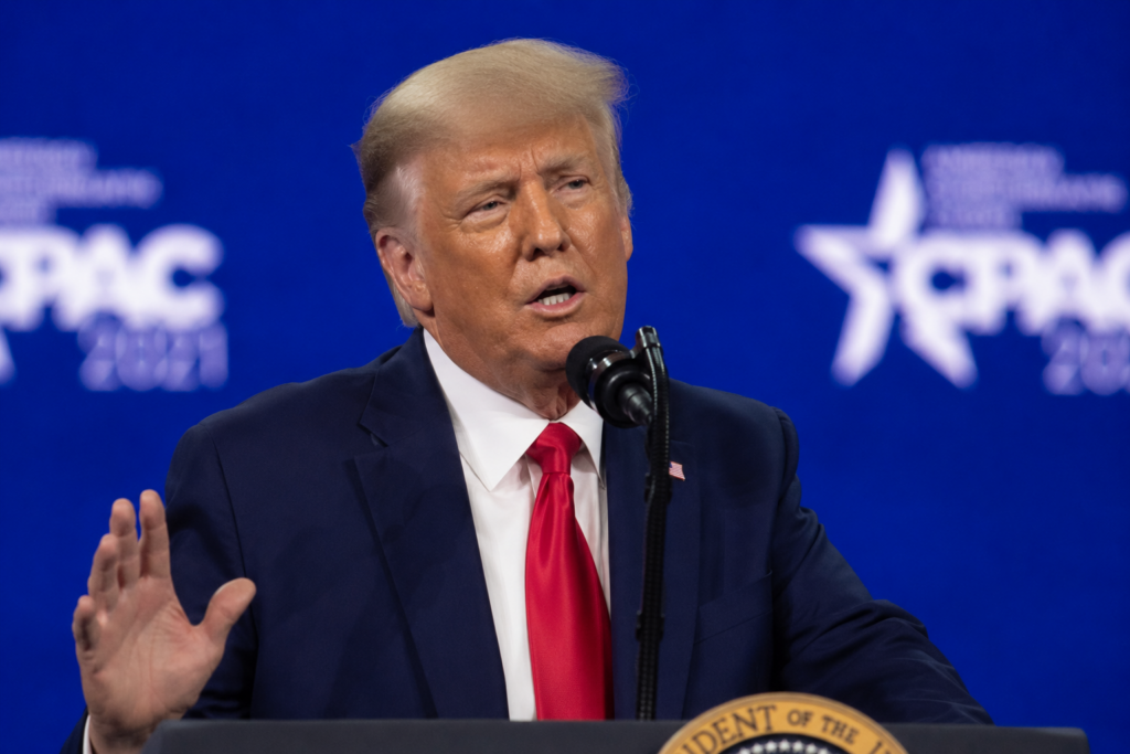DJT stock flashes a warning sign as Trump Media risks build Donald Trump speaking at a conference