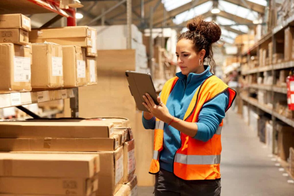 This 4.2% Dividend Stock Pays Cash Each and Every Month warehouse worker takes inventory in storage room