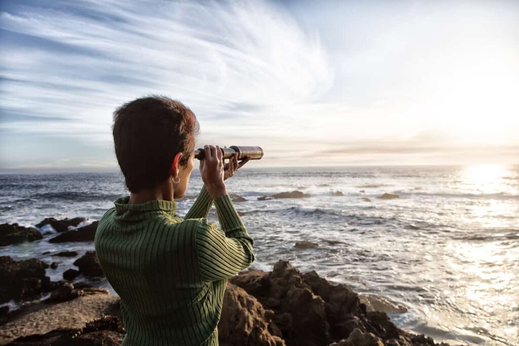 This 5.9% Dividend Stock Is One I’ll Never Sell — Here’s Why person with spyglass looks at ocean horizon