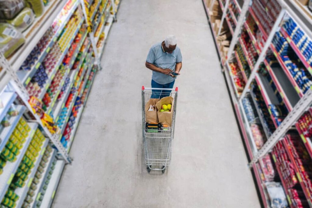 What $10,000 in Dollarama Became in 10 Years man shops at grocery store